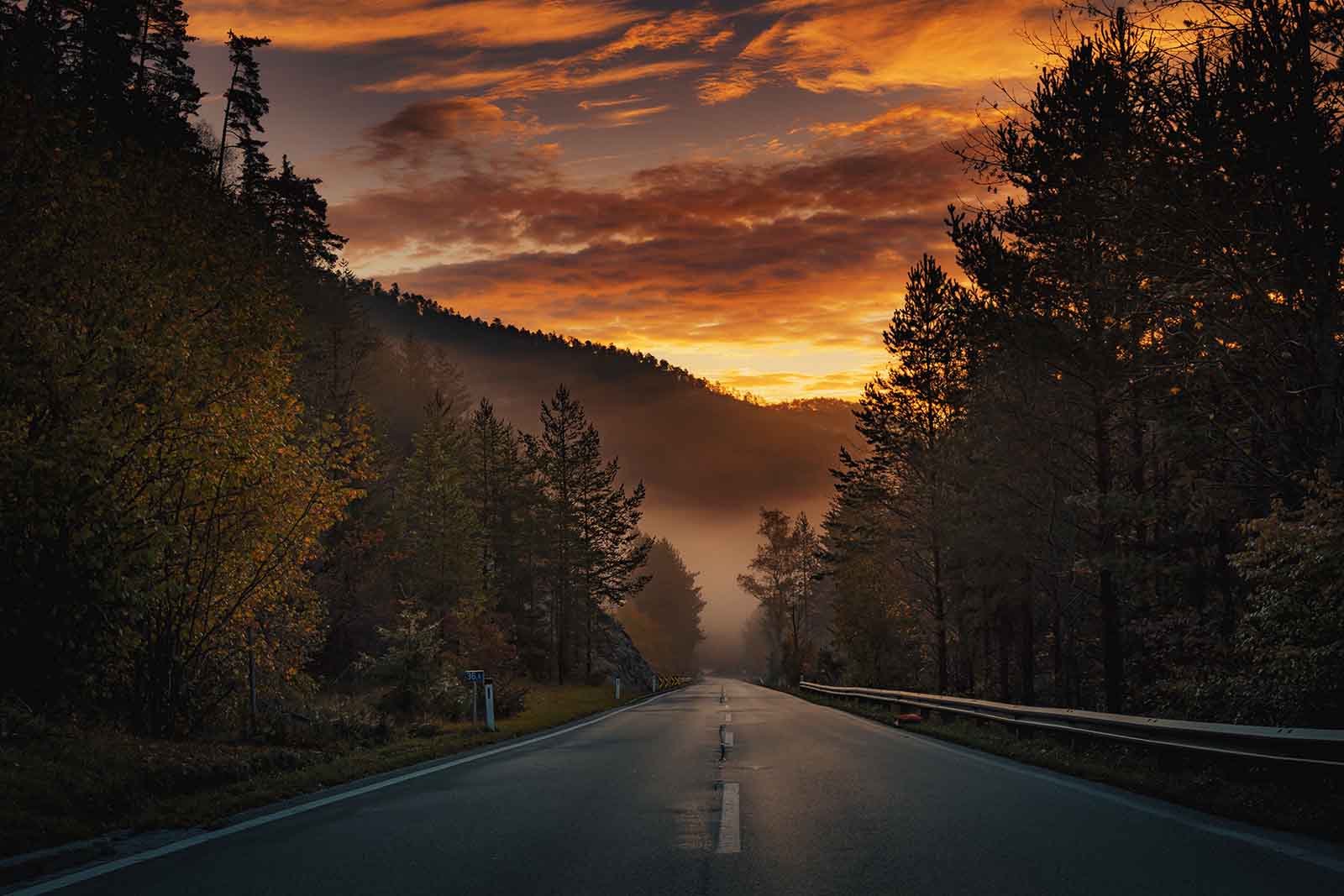 Picture of an open road with a sunset sky